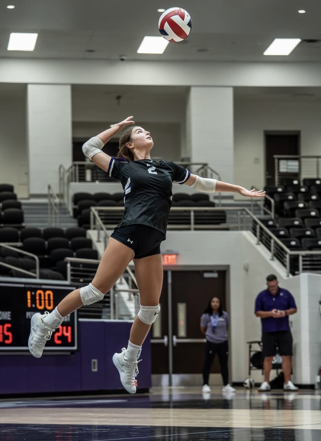 Richland Raiders girls volleyball player serving during a match